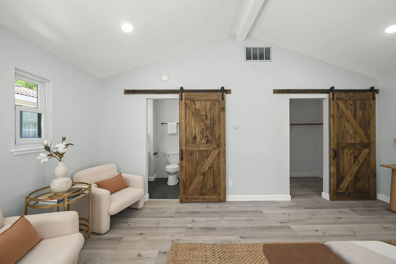 Guest suite sitting area beside two sliding barn doors